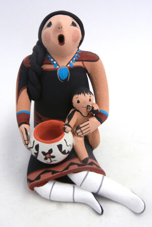 Jemez seated storyteller figurine with one child and piece of pottery by Joyce Lucero