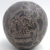 Mata Ortiz handmade and etched black and buff skull and flower design jar by Jose A