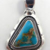 Navajo small turquoise and sterling silver rounded triangular pendant by Wydell Billie